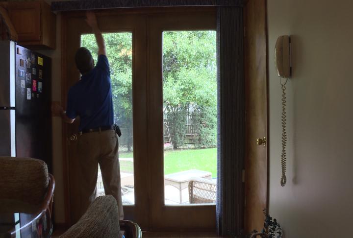 Be Prepared Winterizing Your Home Wgem Com Quincy News Weather Ameren Official Checks The Sealing Around A Sliding Glass Door